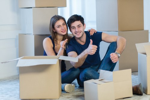 Worker assessing access and carrying items carefully during a move