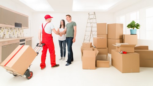 Professional movers handling furniture in a local London flat