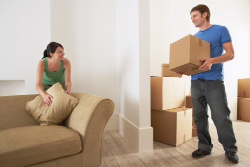 Professional movers using straps and blankets to protect belongings